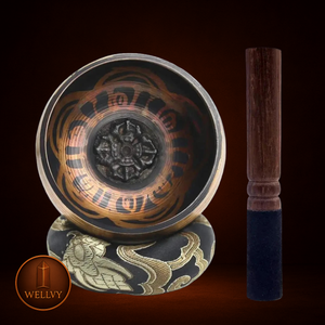 Decorative bowl with intricate designs and a wooden stick on a dark background, featuring the Welly brand.